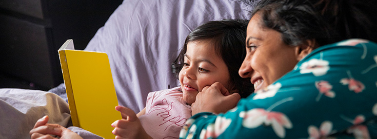 Parent comforting a child with flu symptoms at home
