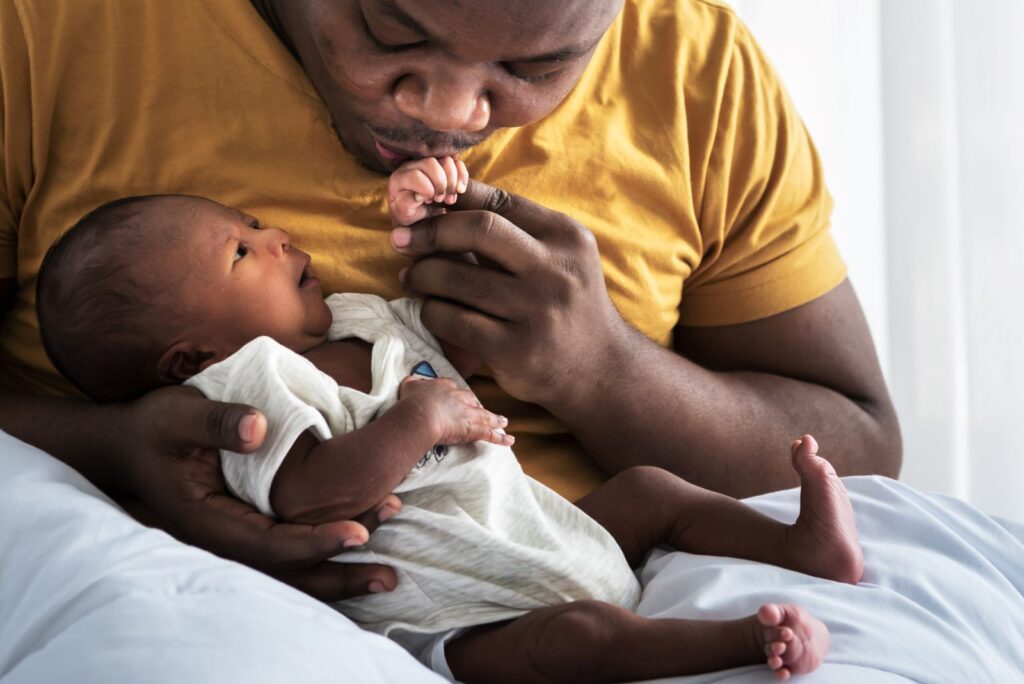 Parent holding a newborn baby, representing RSV in babies and respiratory illness prevention